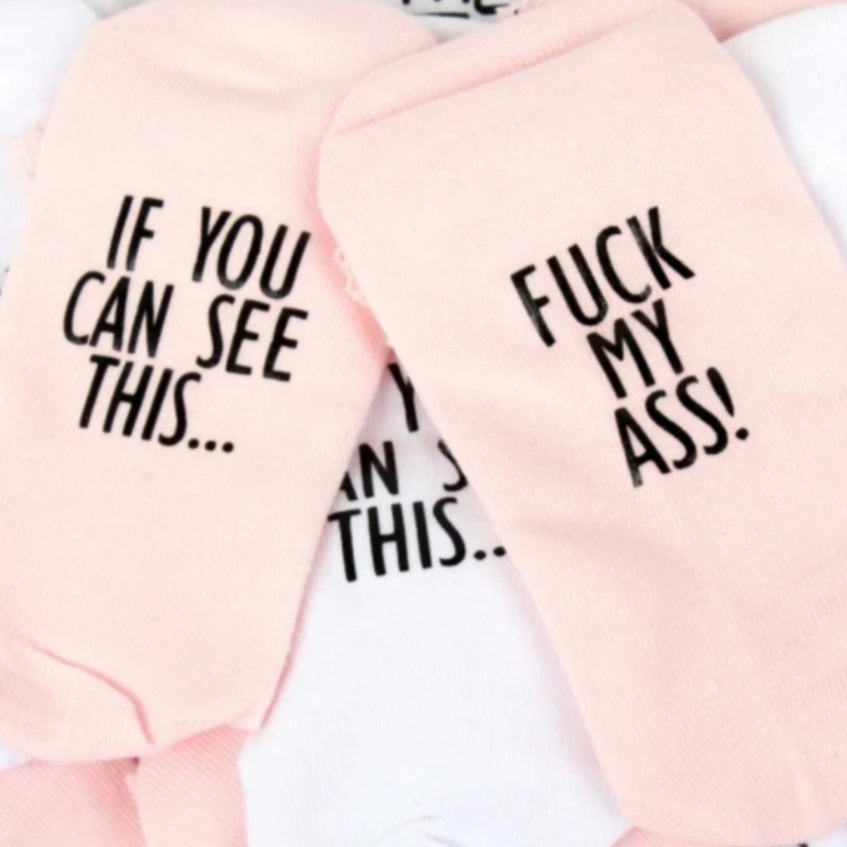 Pink socks with writing underneath saying if you can read this fuck my ass funny clothing