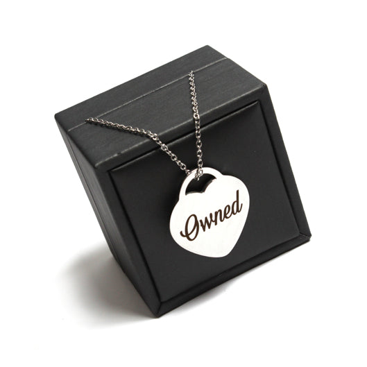 Heart shaped necklace engraved with Owned on a chain in stainless steel