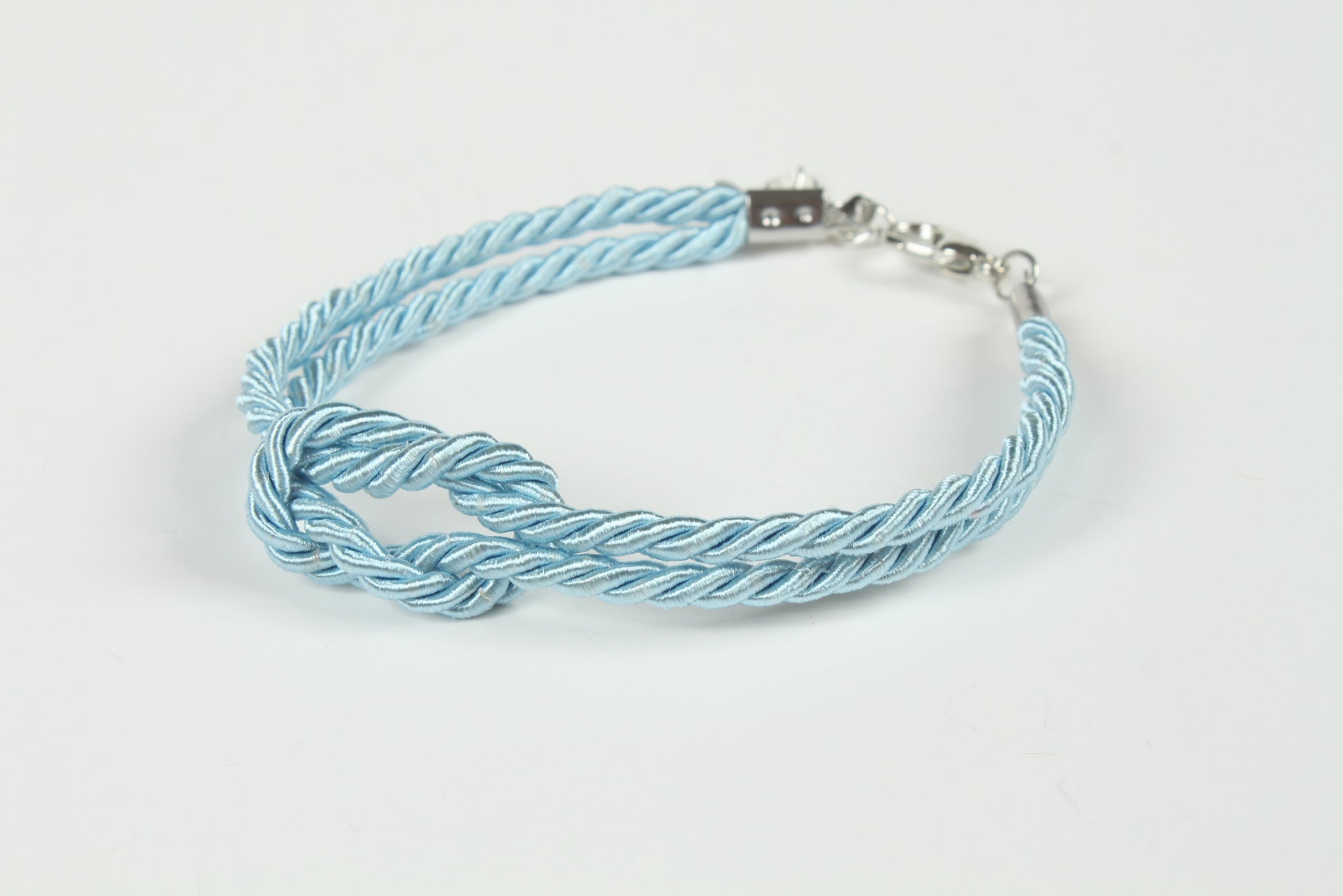 Blue knot bracelet styled for submissives, brats, and rope lovers