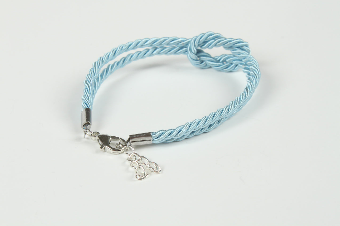 Shibari-inspired bracelet in light blue with symbolic knot detail