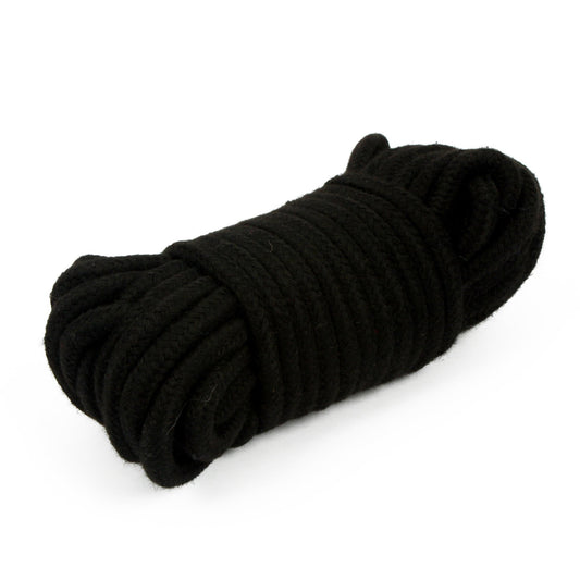 Soft black bondage bdsm rope coiled on a white surface, ready for exploration