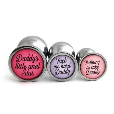 set of metal butt plugs personalized with ddlg phrases