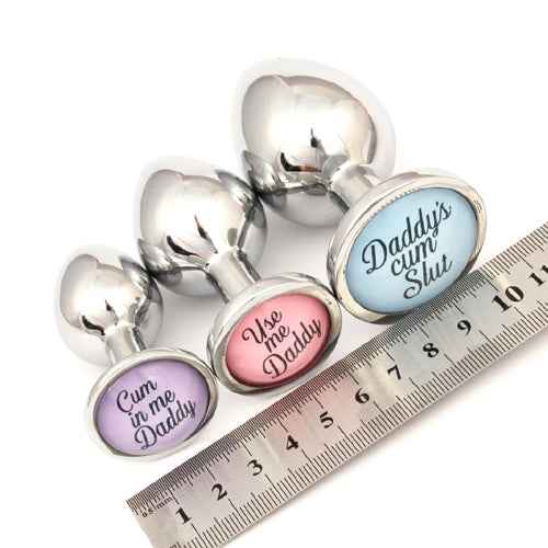 set of custom butt plugs against ruler to show sizes